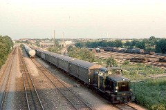 MH 348 photographed at the shunting yard in Fredericia, July 1976.  Built by Frichs, Denmark in a number of 120. The class was put in service in 1960 - 1965. C0. Dieselhydraulic 8-cyl MAN engine. 440 hp. Max speed 60 km/h - 37 mph. Length 9 440 mm. Weight 45 metric tonnes. MH 348 was put in service in 1962. Withdrawn from service in 1997. Scrapped in 2001.